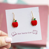 Red enamel apple charms on gold plated drop earrings presented on a Best Teacher Ever sentiment card.