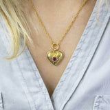 Model wears Ribbed Heart Necklace with January Garnet Birthstone Detail