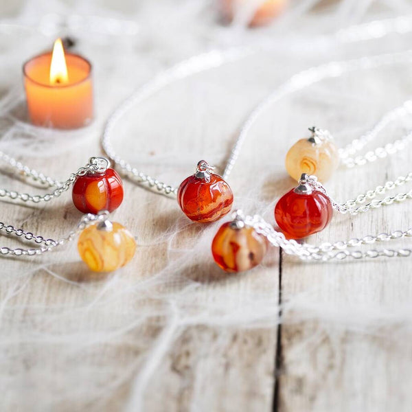 Silver red agate gemstone pumpkin necklaces shown in a variety of shades.