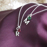 Image shows Silver Plated Initial And Birthstone Star Necklace in May emerald and July Ruby