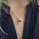 Model wears Silver Plated Initial And Birthstone Star Necklace in July Ruby