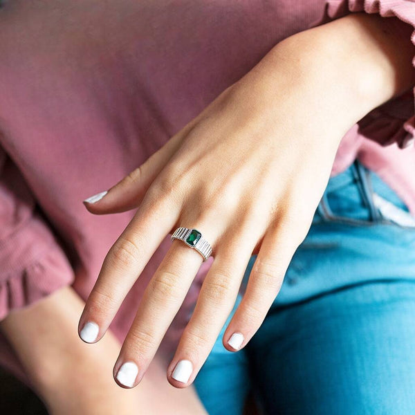 Silver plated ribbed baguette birthstone ring  displayed with the Emerald birthstone.