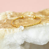 Image shows Solitaire Crystal Stacking Ring on a pink backdrop