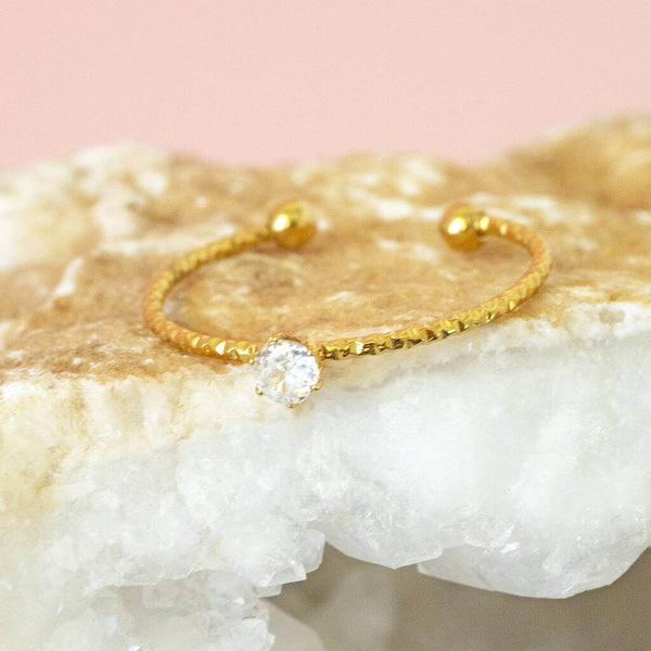 Image shows Solitaire Crystal Stacking Ring on a pink backdrop