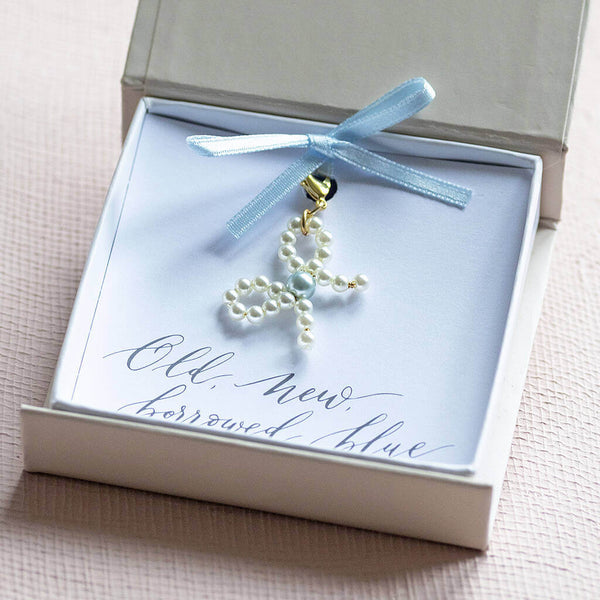 dainty pearl bow charm with a blue pearl in the centre for the bow presented in a joy by Corrine Smith gift box on an old, new, borrowed, blue sentiment card