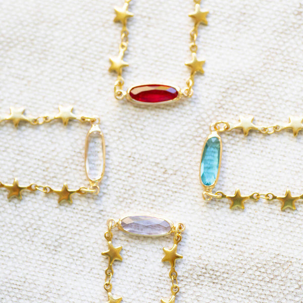 Image shows four Star Chain Necklaces with Birthstone Detail on a white backdrop.