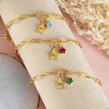 Image shows three gold plated star charm bracelet with birthstone star. From top to bottom: March birthstone star, July birthstone star and May birthstone star.