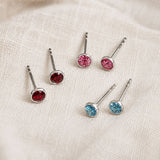 Colourful sterling silver birthstone studs in red, pink and blue, perfect for a bright minimalist ear stack.
