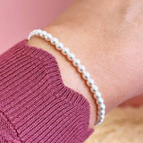 Model wears Stretch Pearl Stacking Bracelet.