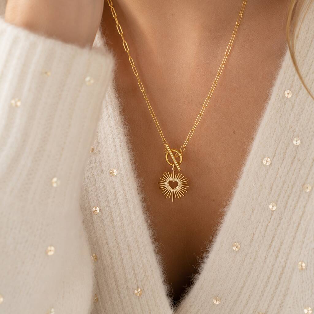 Gold sunburst heart pendant with T bar fastening, timeless statement jewellery for effortless layering.