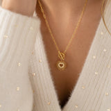 Gold sunburst heart pendant with T bar fastening, timeless statement jewellery for effortless layering.