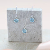 image shows Swarovski crystal birthstone jewellery using aquamarine 0.6cm birthstones displayed on a grey marble block