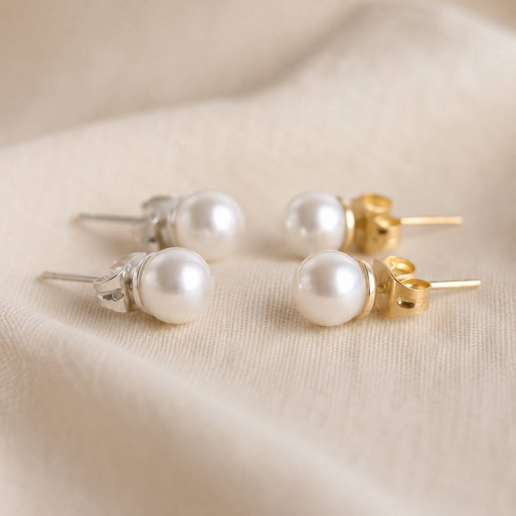 White Swarovski pearl stud earrings available in silver and gold tone finishes for versatile everyday wear