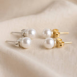 White Swarovski pearl stud earrings available in silver and gold tone finishes for versatile everyday wear