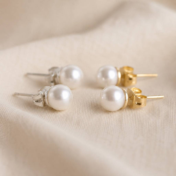 White Swarovski pearl stud earrings available in silver and gold tone finishes for versatile everyday wear