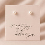 White Swarovski pearl stud earrings presented on a sentimental wedding card for elegant gifting