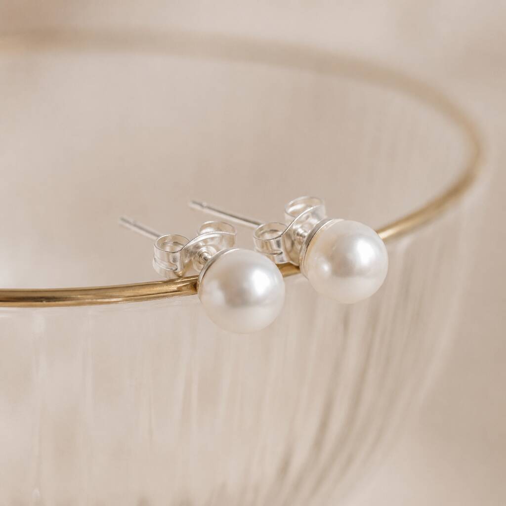Classic white Swarovski pearl stud earrings with a polished finish, ideal for everyday jewellery styling