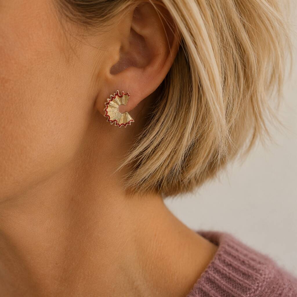Gold pencil shaving stud earrings with red enamel detail styled for everyday wear with a cosy lilac knit