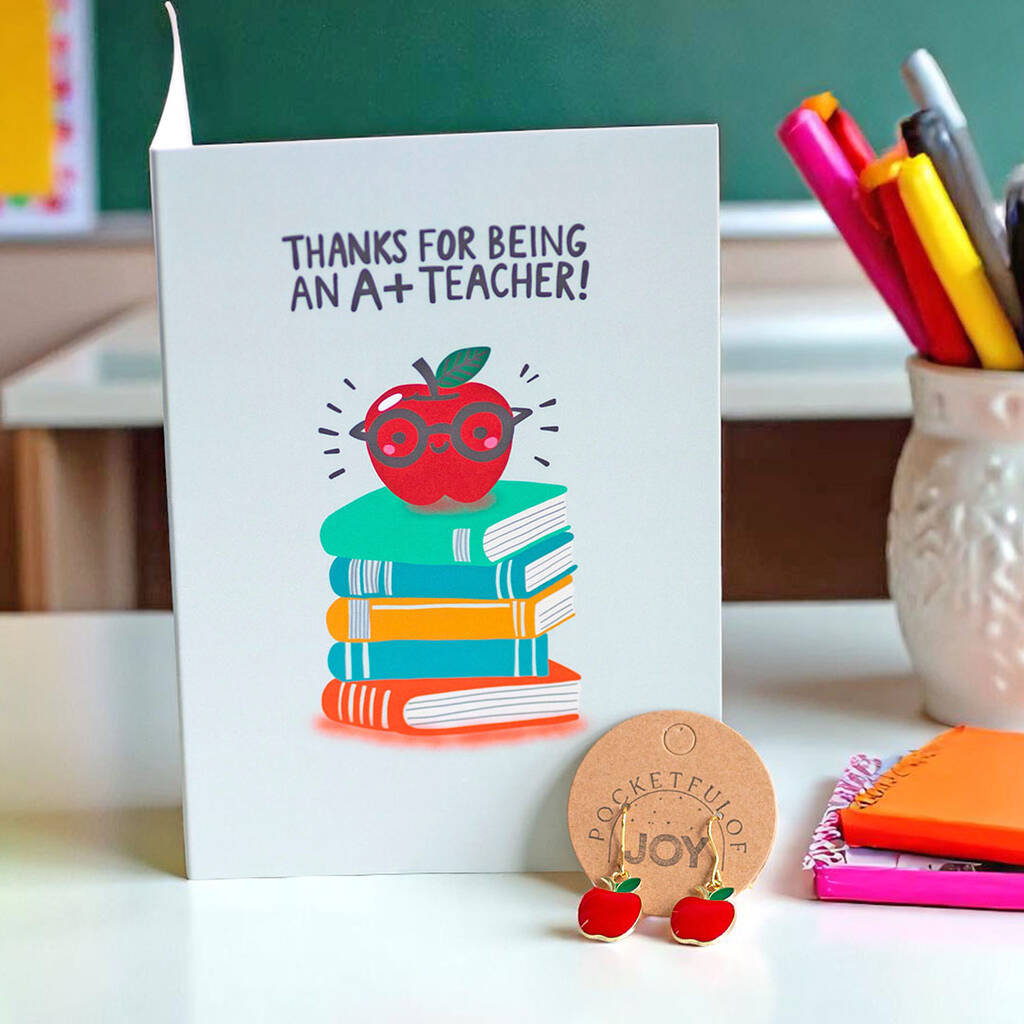 Thank You Teacher card with illustrated apple and stack of books, paired with red apple enamel drop earrings.