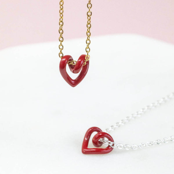 Image shows from left to right - Tiny Red Enamel Floating Heart Necklace with gold chain and silver chain.