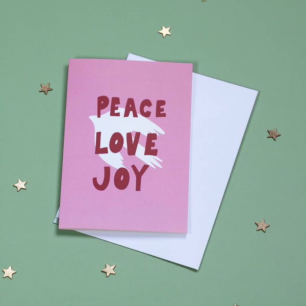 Pink card with 'Peace Love Joy' text on a green background with stars