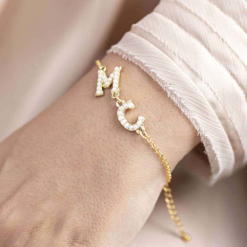 Personalised Double Pearl Initial Bracelet featuring letters M and C on a gold chain shown on model