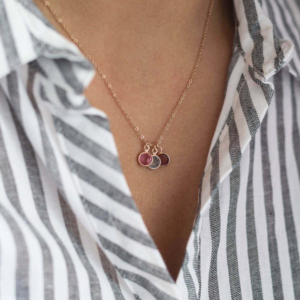 Rose gold necklace with three birthstone charms attached