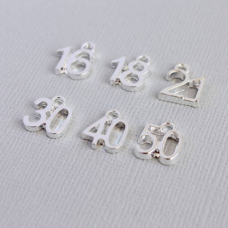 Image shows some of the number charms available in silver plated brass; '16, '18', '21', '30', '40' and '50'.