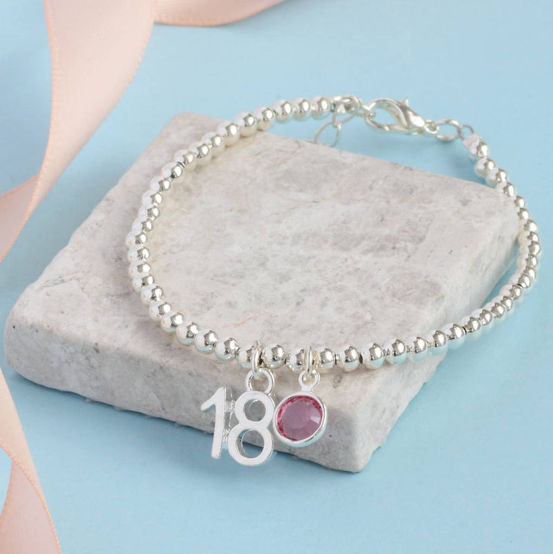 Image shows silver plated 18th birthday beaded birthstone charm bracelet with an '18' charm and an October Rose Swarovski birthstone crystal.