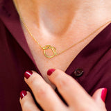 Model wears gold plated Friendship Knot Necklace.
