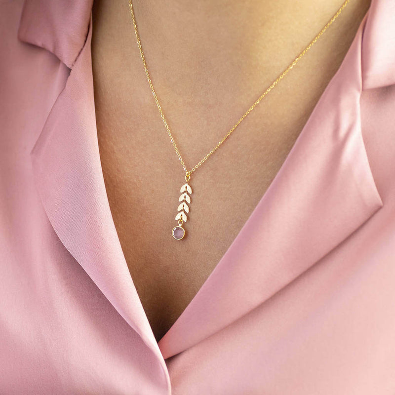 Model wears gold leaf vine necklace with October Rose Swarovski birthstone.