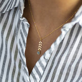 Model wears gold leaf vine necklace with March Aquamarine Swarovski birthstone.