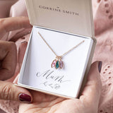 Image shows rose gold family marquise style birthstone necklace with three Swarovski birthstone marquise style charms from left to right: October rose birthstone, December blue zircon birthstone and June light amethyst. Displayed on a  'Mum' sentiment card within the JOY branded gift box.