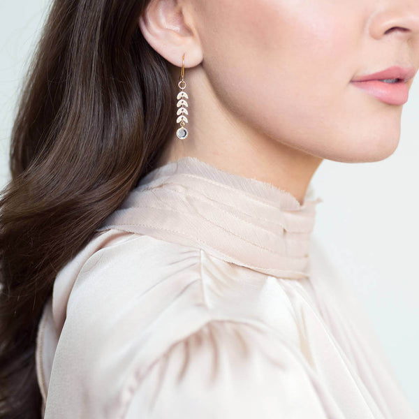 Model wears gold leaf vine earrings with April Crystal Swarovski Birthstone detail.