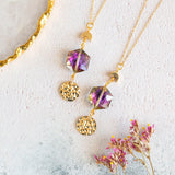 images shows purple hex eclipse necklace with full moon charms on a white background.