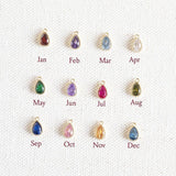 Images shows oval shaped crystal birthstones available from top left; Garnet January, Amethyst February, Aquamarine March, Crystal April, Emerald May, Light Amethyst June, Ruby July, Peridot August, Sapphire September, Rose October, Yellow Topaz November, Blue Zircon December.