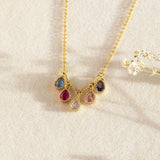 image shows family birthstone necklace with teardrop crystals. Five birthstones to represent five family members or loved ones.