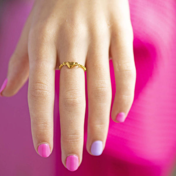 Model wears Adjustable Chain Ring with Heart Detail.