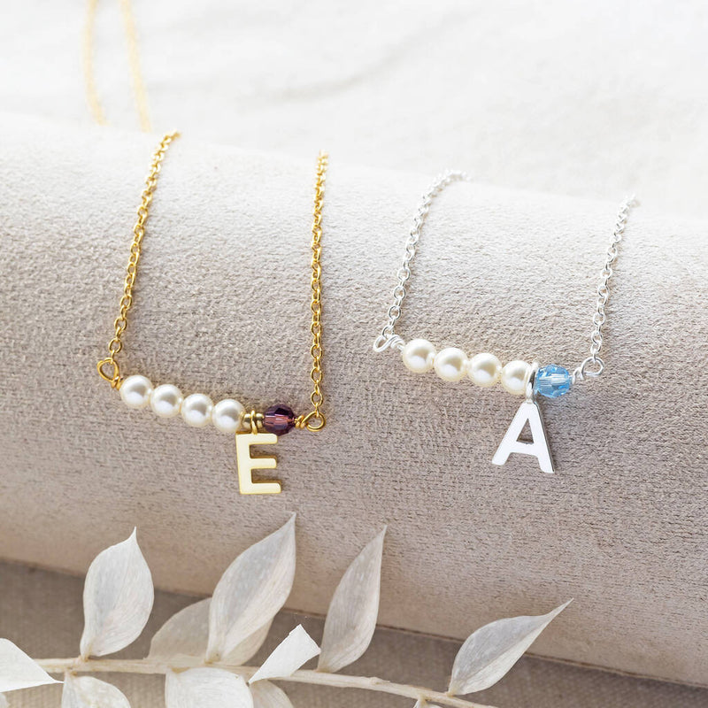 Image shows gold and silver asymmetric pearl and birthstone initial necklace