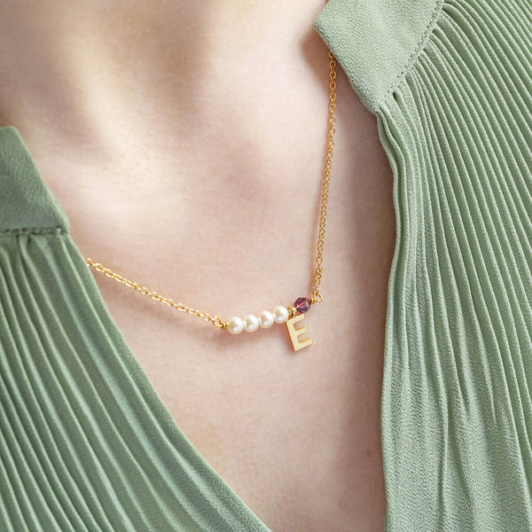 Image shows model. wearing asymmetric pearl and birthstone initial necklace