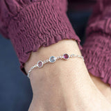 Model wears silver Family Birthstone Link Bracelet with three Swarovski Birthstone Gems (up to 10 can be selected) in Amethyst, Aquamarine and Light Amethyst for February, March and June.