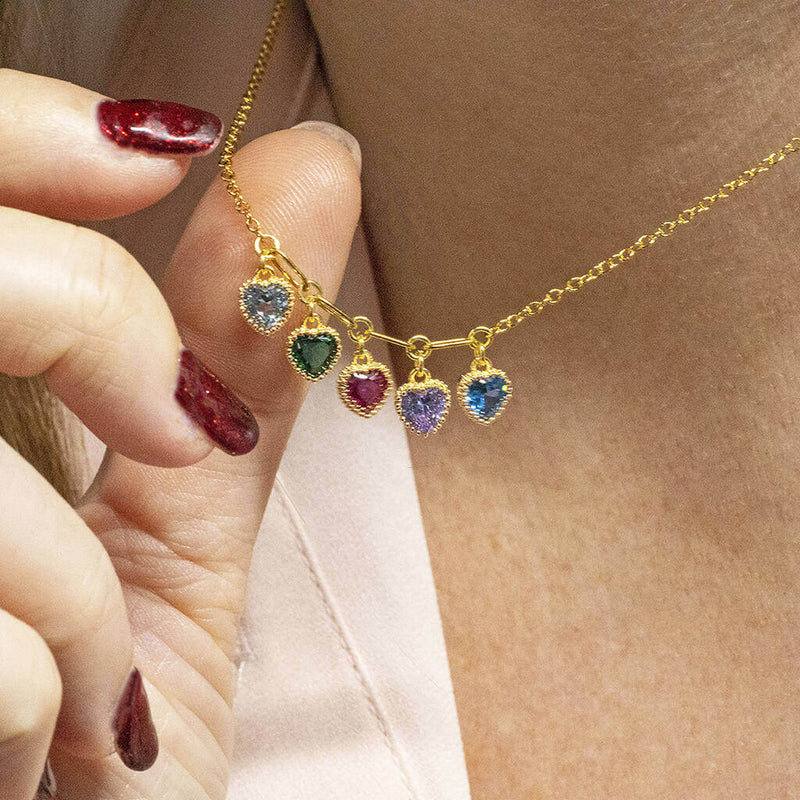 model wears family birthstone necklace with heart crystal birthstones.