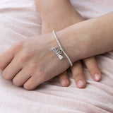model wearing silver beaded graduation gift charm bracelet handmade personalised jewellery