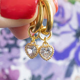 Image shows gold huggie hoops with April crystal birthstone heart detail
