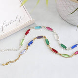 image shows one gold plated and one silver plated oval link family birthstone bracelet.