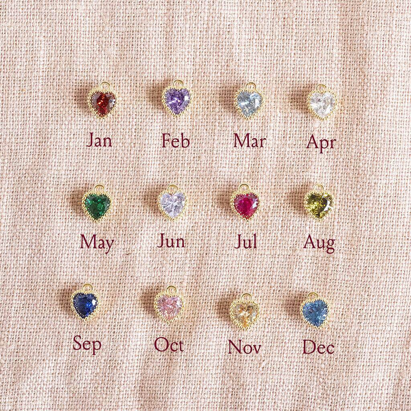 Image shows heart shaped crystal birthstones available from top left; Garnet January, Amethyst February, Aquamarine March, Crystal April, Emerald May, Light Amethyst June, Ruby July, Peridot August, Sapphire September, Rose October, Yellow Topaz November, Blue Zircon December.