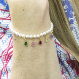 model wears a stretch bracelet with pearls and family birthstone teardrop charms