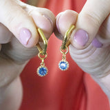 Image shows Square Huggie Earrings With December Birthstone Detail 