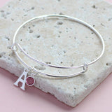 Image shows personalised initial birthstone bangle with initial 'A' and a Swarovski birthstone charm.