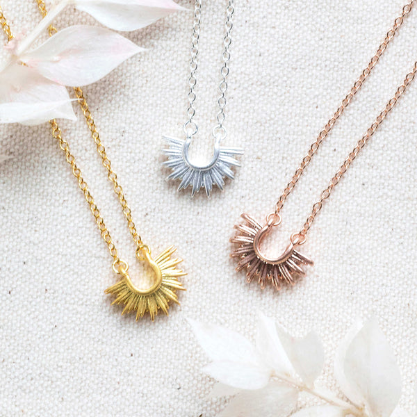 Image shows Ray of Sunshine Positivity Necklace, form left to right in gold, silver or rose gold plated brass.